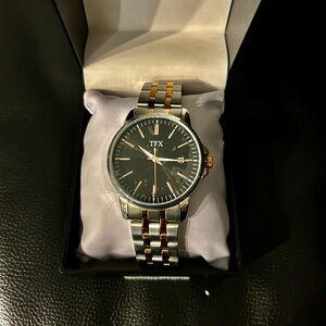 New in original box, men’s TFX watch. Metal band.